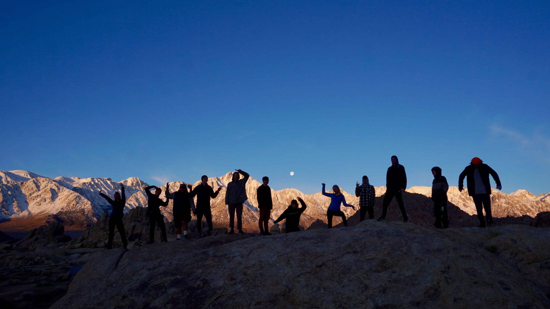 students lined up on a hill at sunset