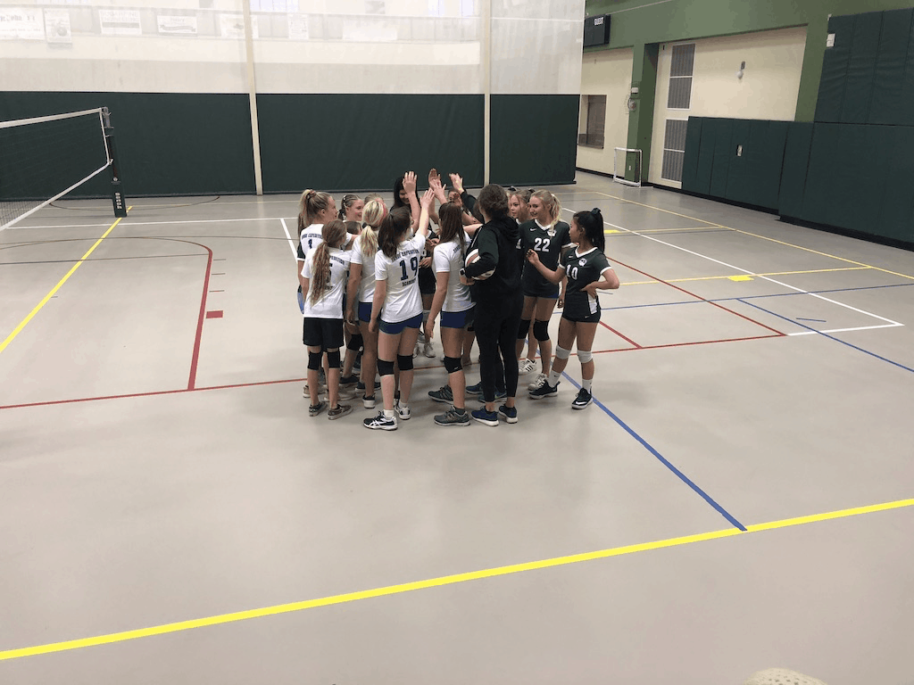 TEA volleyball team huddled together