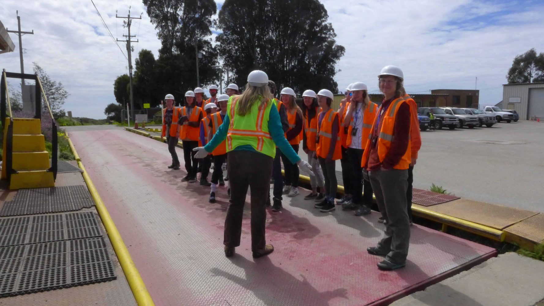 students lined up in hard hats and high visibility jackets