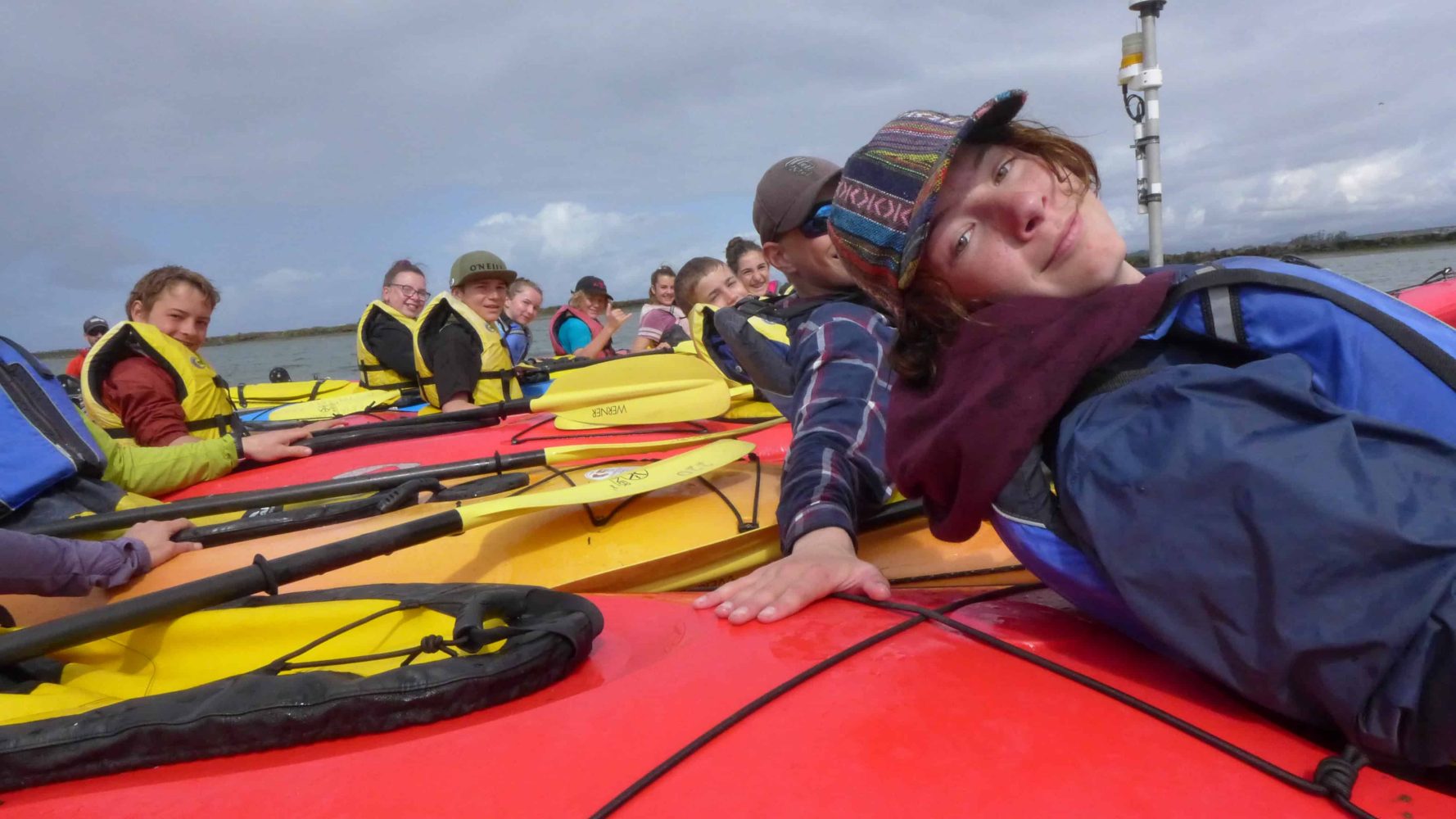 students on kayaks in the ocean