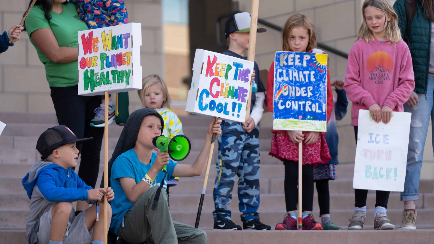 kid with a megaphone speaking at the protest