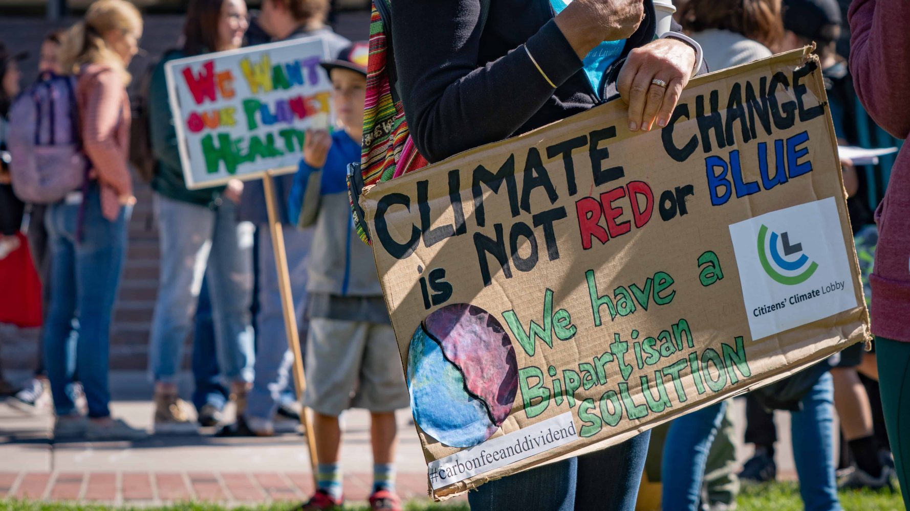 a student holding a sign for climate change