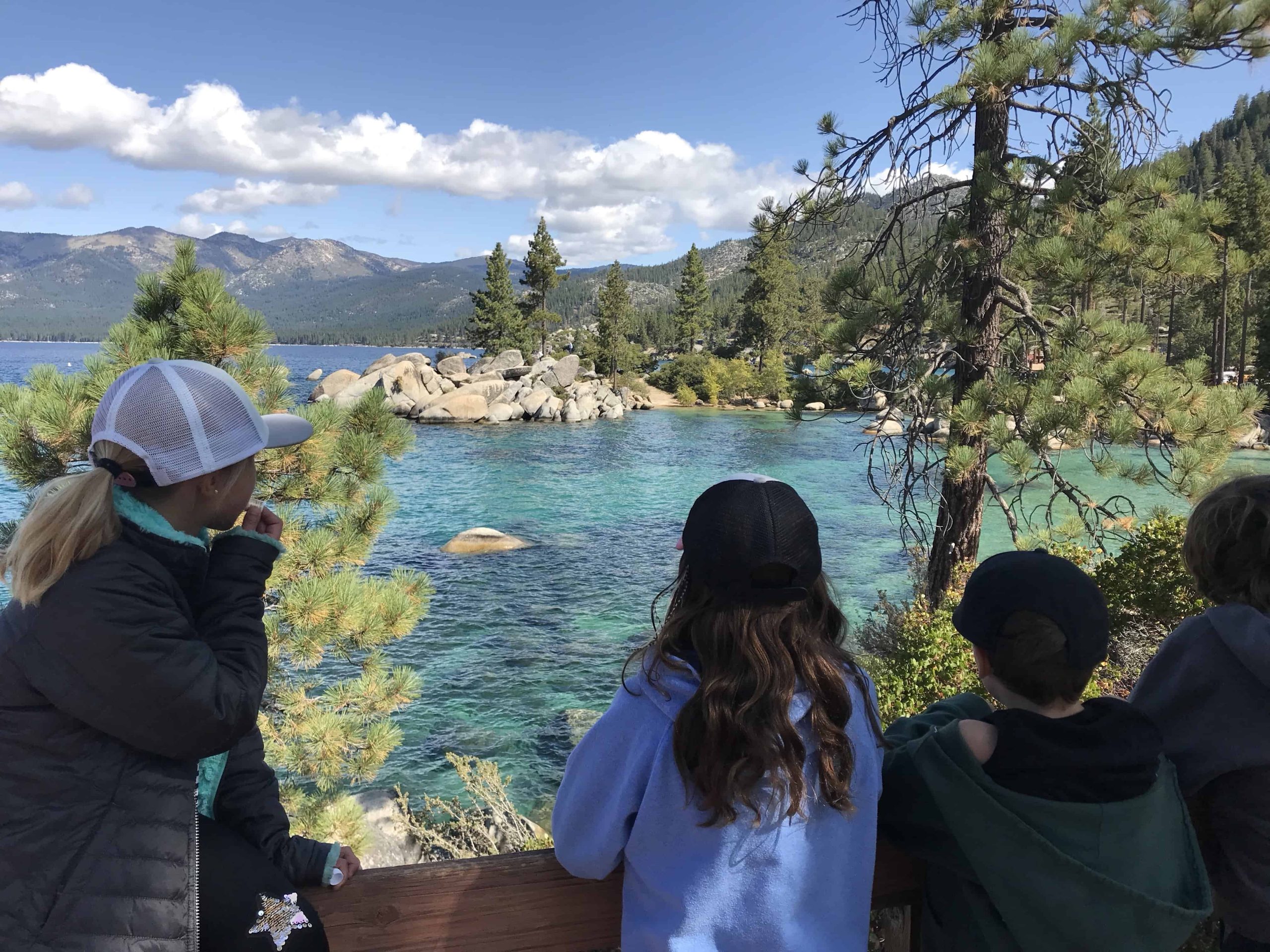students look out at the lake from sand harbor