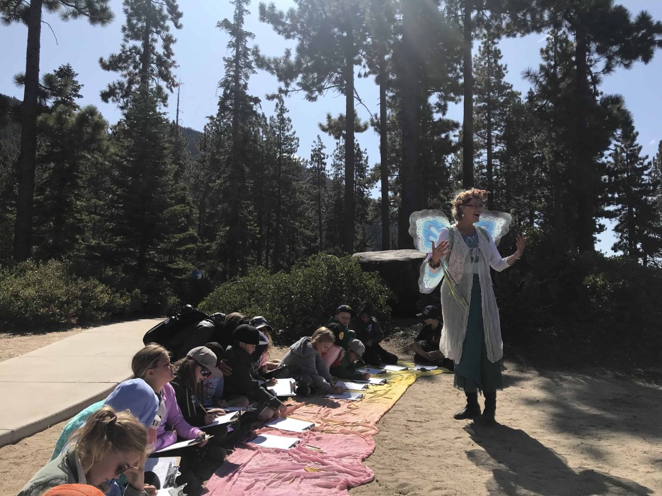 a teacher gives a lecture while students sit and take notes