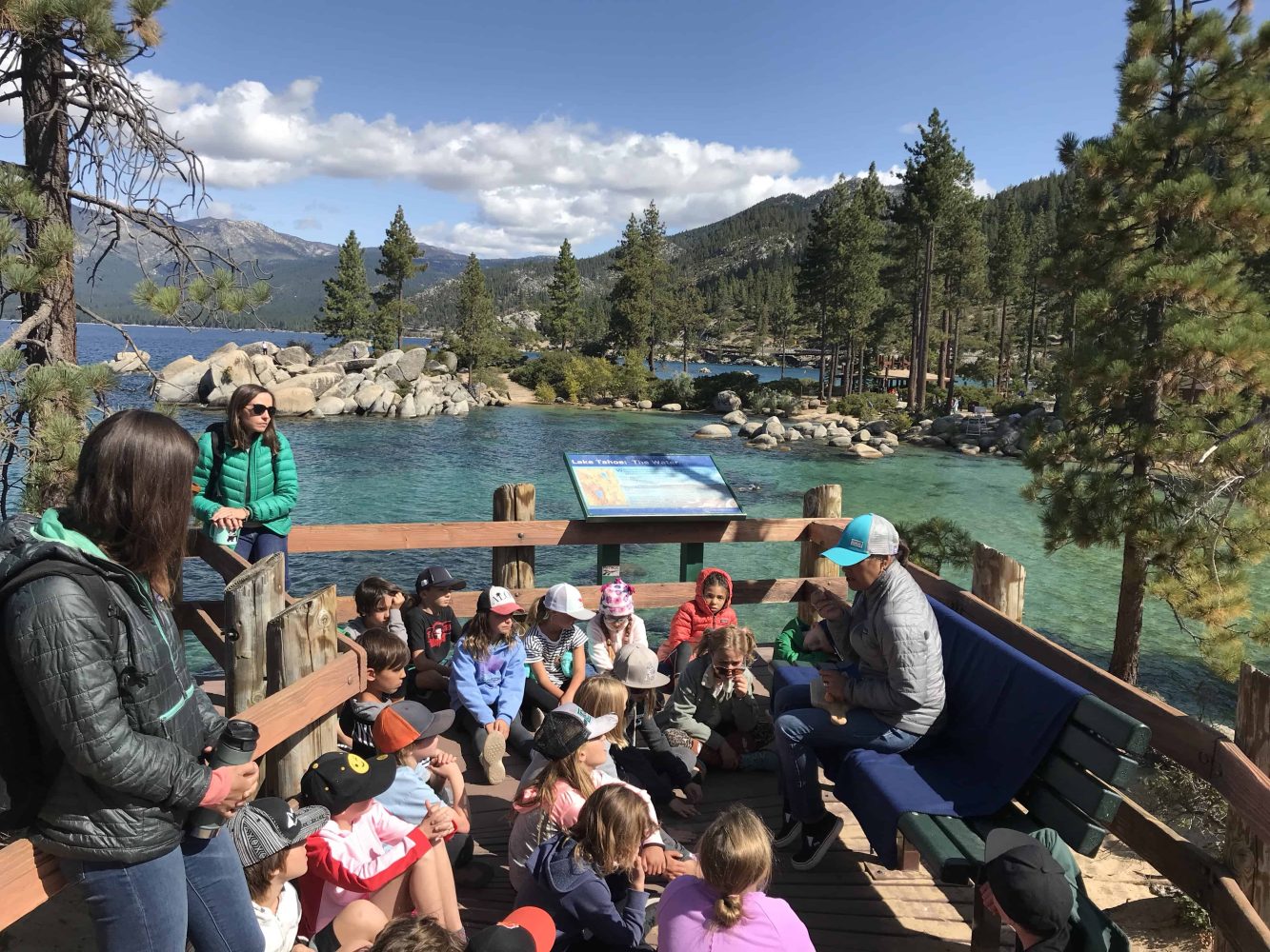 students on a deck gathered around a teacher