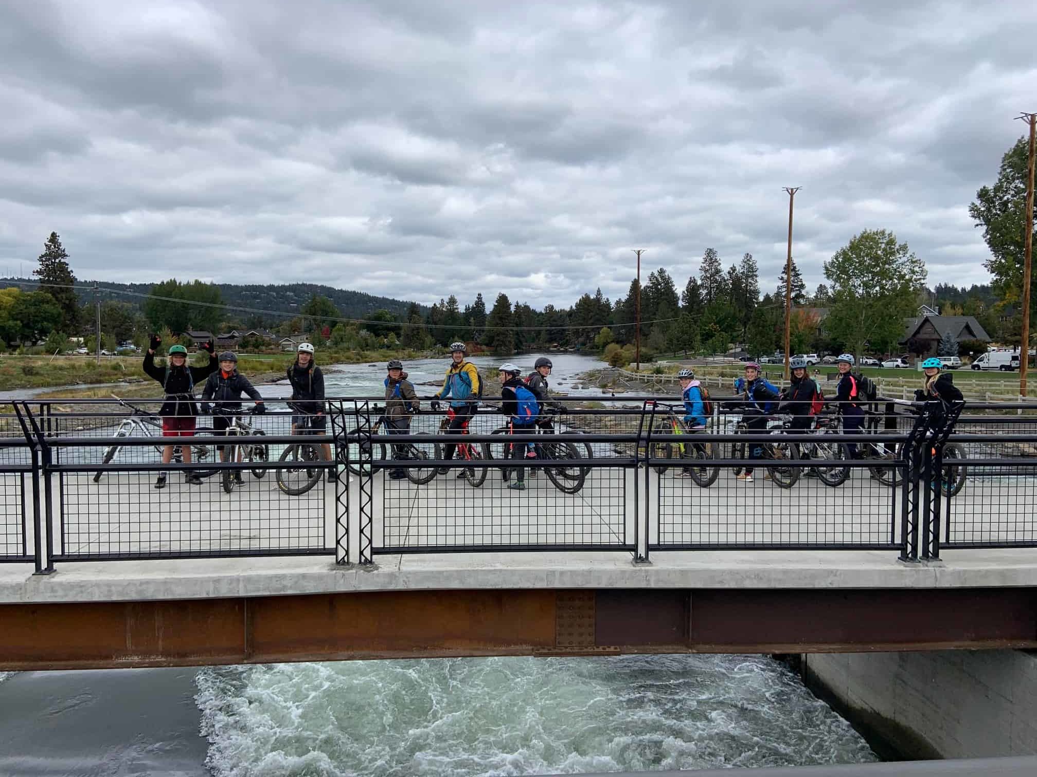 students with bikes on a deschutes river bridge