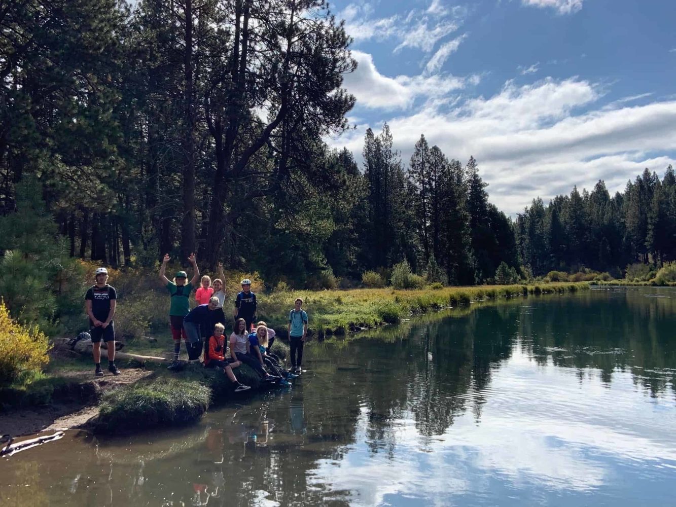 kids sitting next to the deschutes river