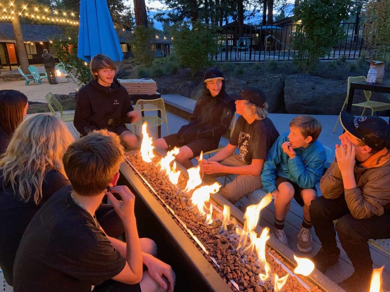 kids sitting around a fire at night