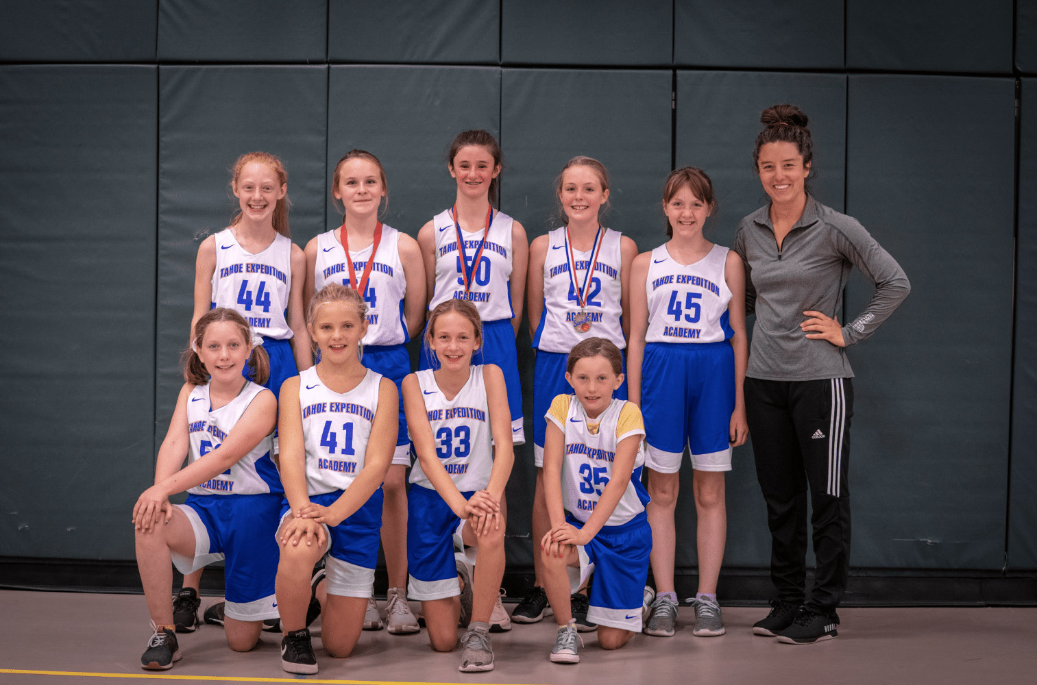 the girls basketball team posing for a picture