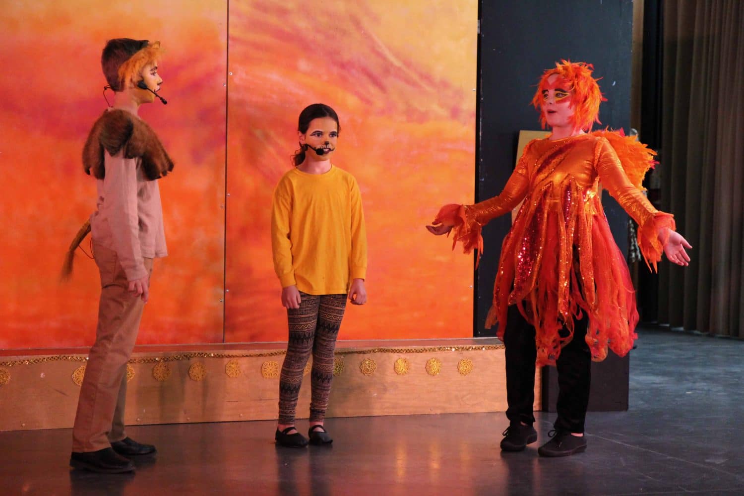 the drama club performing the lion king onstage