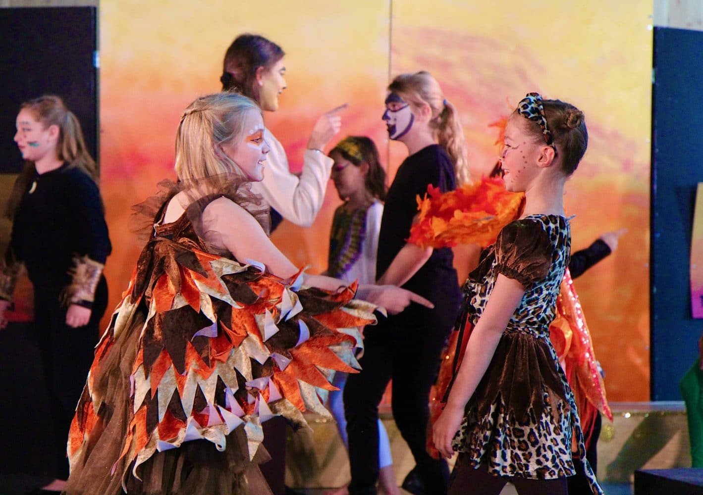 the drama club performing the lion king onstage