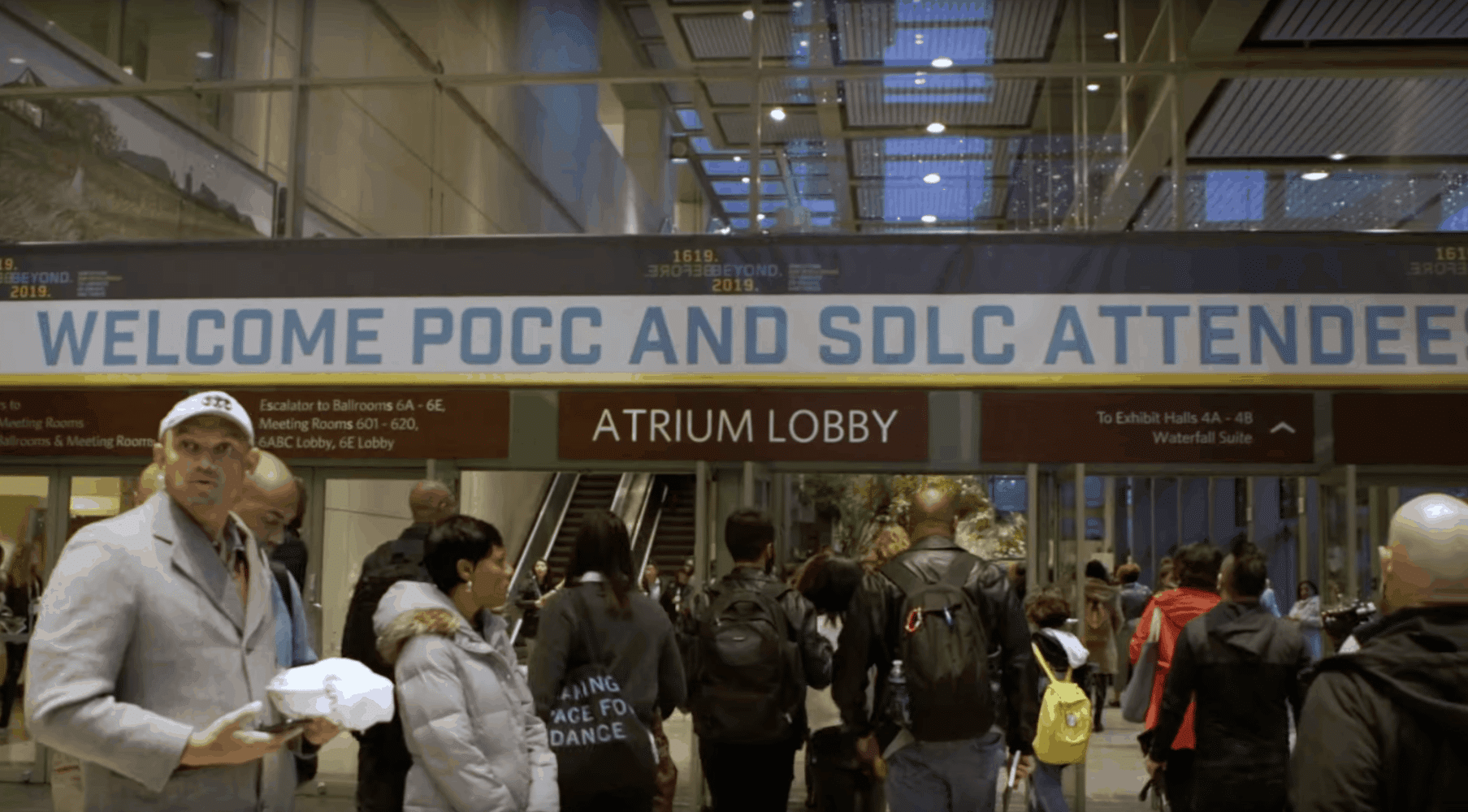 a view of people walking through the conference