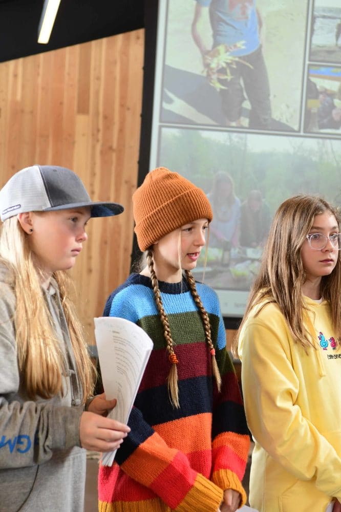 three students in the presenters group