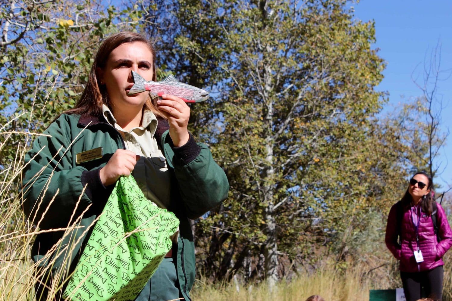 a student with a bag in one hand and a fish in the other