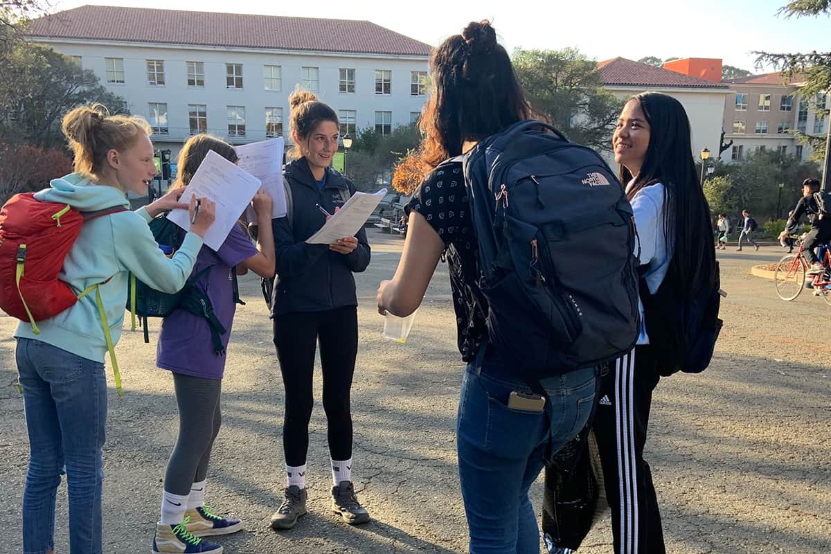 students with backpacks gathering outdoors
