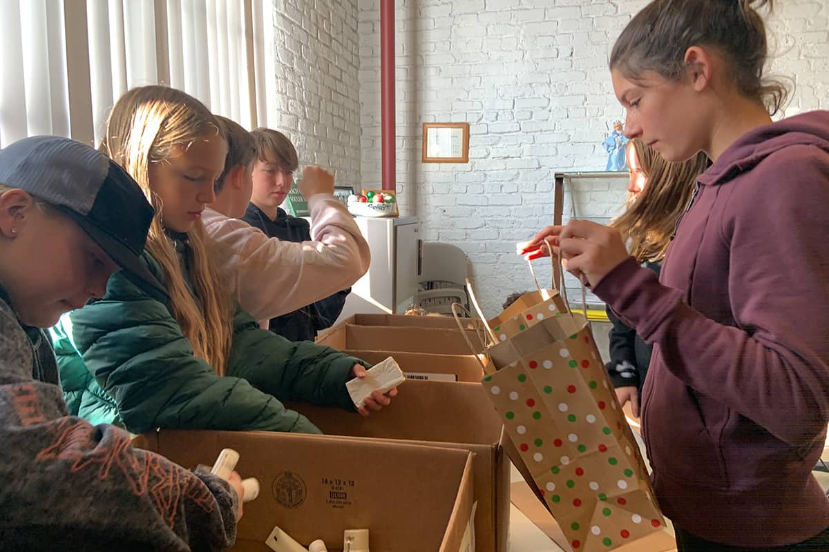 a group of students packing giftbags