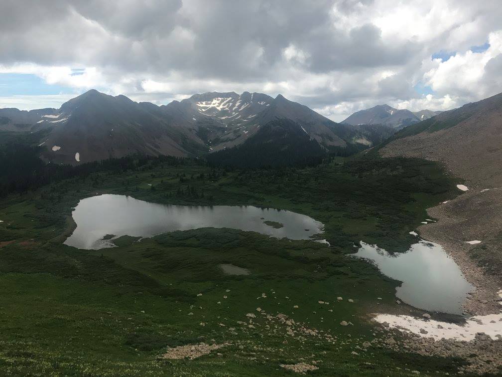 cloudy view of a valley from atop a hill